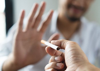 Hand turning down the offer of a cigarette