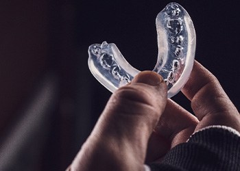 Hand holding clear mouthguard
