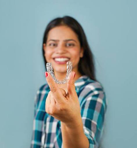 Close-up of person’s mouth as they use clear aligner