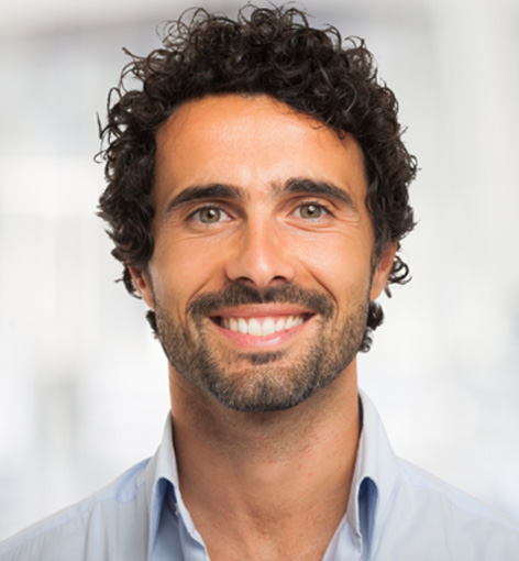Young man smiling with healthy dental crowns in Hayward