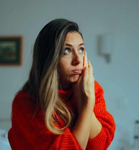 Frowning young woman with a toothache